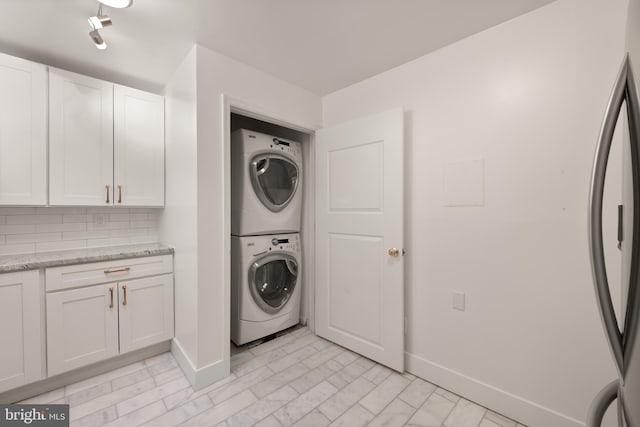 4620 N Park Ave N Unit 1206E, Chevy Chase, MD 20815 - laundry area featuring stacked washer / drying machine and baseboards