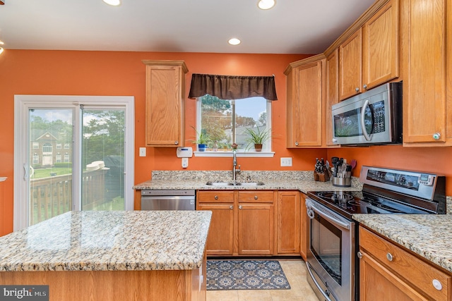 10578 Talisa Ln, Manassas, VA 20112 - kitchen with stainless steel appliances, a sink, light stone counters, recessed lighting, and a kitchen island