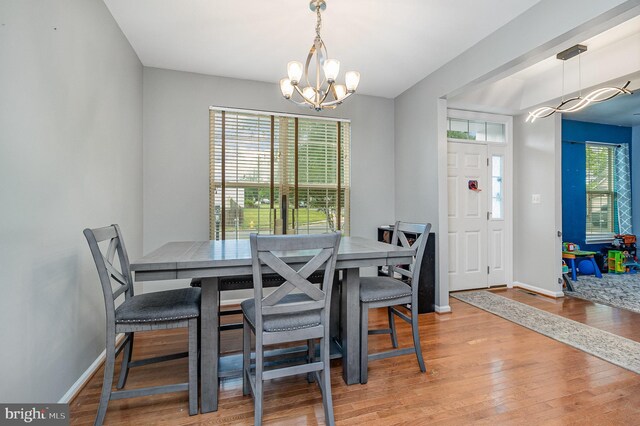 10578 Talisa Ln, Manassas, VA 20112 - dining area featuring a chandelier, healthy amount of natural light, wood finished floors, and baseboards