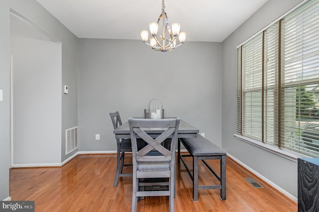 10578 Talisa Ln, Manassas, VA 20112 - dining area with a chandelier, light wood finished floors, and baseboards