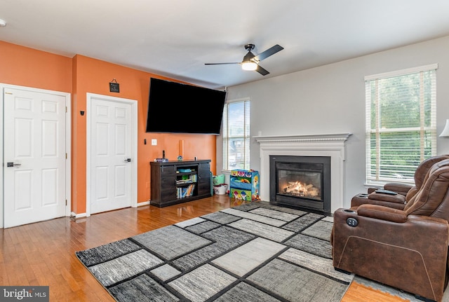 10578 Talisa Ln, Manassas, VA 20112 - living area featuring ceiling fan, healthy amount of natural light, a glass covered fireplace, and wood finished floors