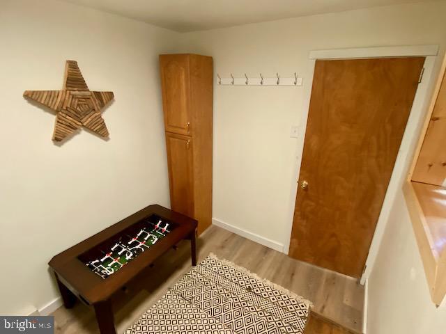 mudroom featuring wood finished floors and baseboards