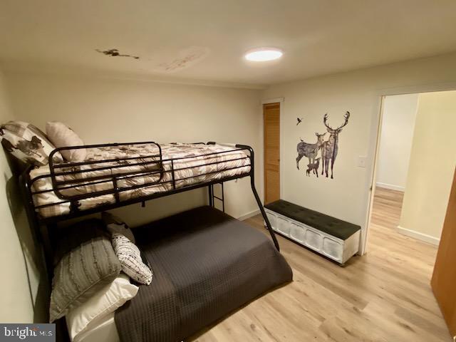 bedroom with light wood-style floors and baseboards