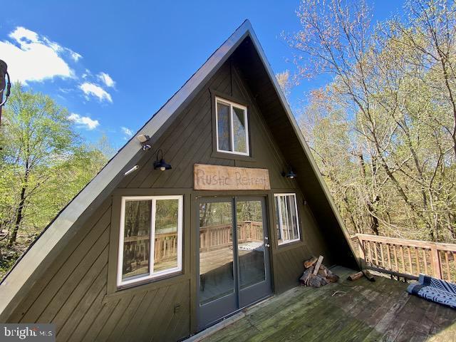 view of side of home with a deck