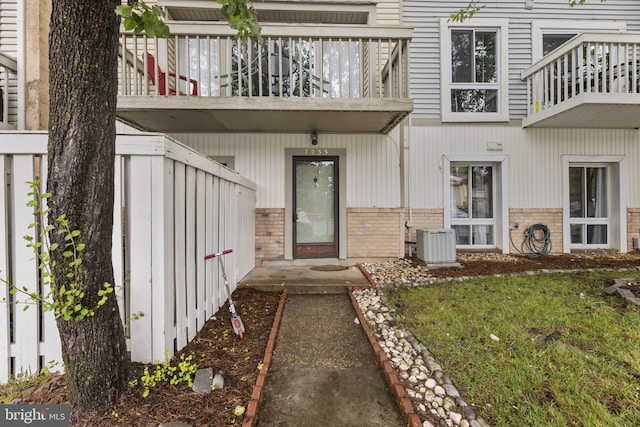 7233 Jillspring Ct Unit 18C, Springfield, VA 22152 - doorway to property featuring brick siding, a balcony, and a yard