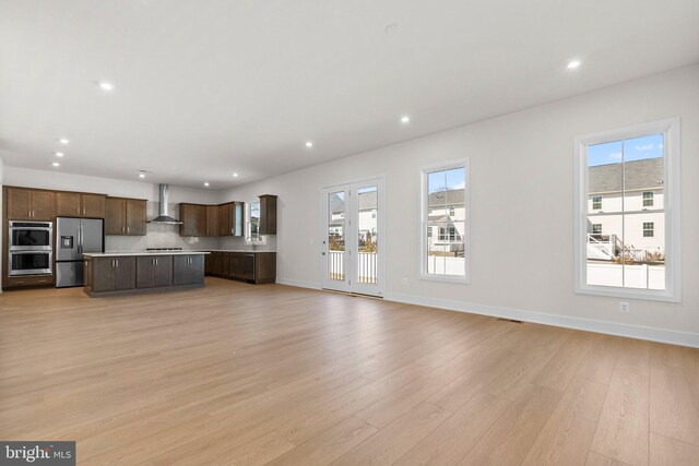 112 Heyford Dr, Stephenson, VA 22656 - unfurnished living room with plenty of natural light, recessed lighting, light wood-style flooring, and baseboards