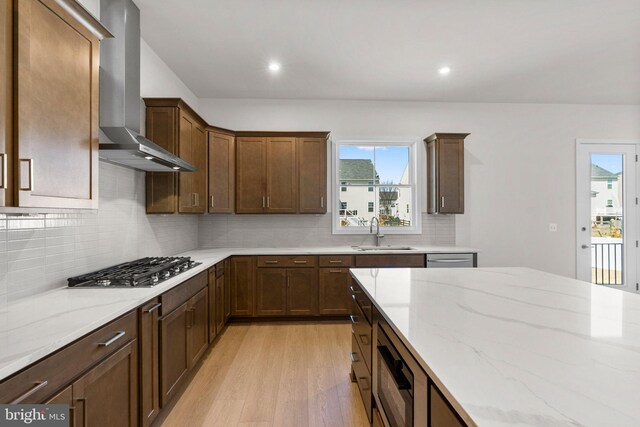 112 Heyford Dr, Stephenson, VA 22656 - kitchen with a sink, wall chimney exhaust hood, light wood-style floors, light stone counters, and recessed lighting