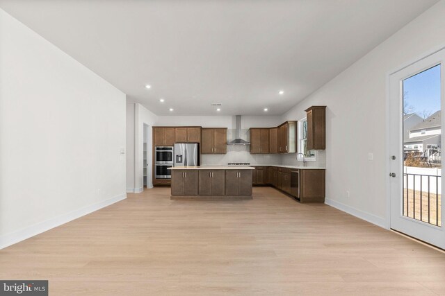 112 Heyford Dr, Stephenson, VA 22656 - kitchen with wall chimney range hood, stainless steel appliances, a sink, light countertops, and recessed lighting
