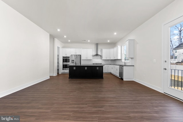 114 Heyford Dr, Stephenson, VA 22656 - kitchen featuring wall chimney range hood, appliances with stainless steel finishes, a kitchen island, dark wood finished floors, and a sink