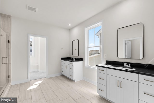 114 Heyford Dr, Stephenson, VA 22656 - bathroom with plenty of natural light, a stall shower, two vanities, baseboards, and recessed lighting