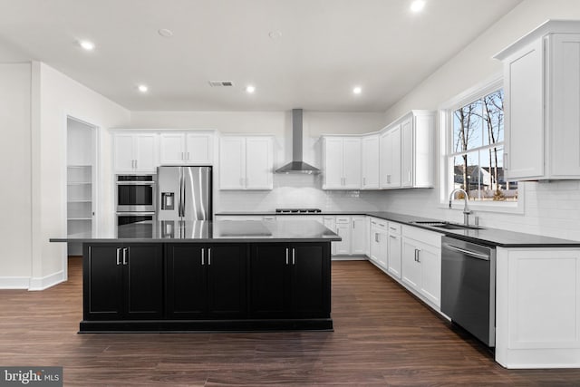 114 Heyford Dr, Stephenson, VA 22656 - kitchen with appliances with stainless steel finishes, a sink, wall chimney range hood, a center island, and backsplash
