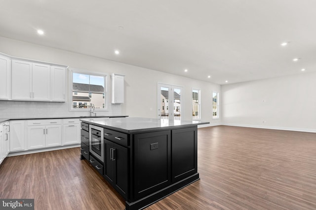 114 Heyford Dr, Stephenson, VA 22656 - kitchen with dark cabinets, white cabinetry, wood finished floors, a center island, and recessed lighting