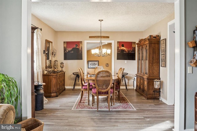 140 Grandview Ave, Hamilton, NJ 08620 - dining space featuring wood finished floors, a chandelier, a textured ceiling, and baseboards