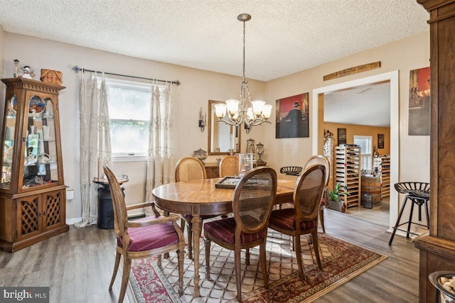 140 Grandview Ave, Hamilton, NJ 08620 - dining area with wood finished floors, a textured ceiling, and a chandelier