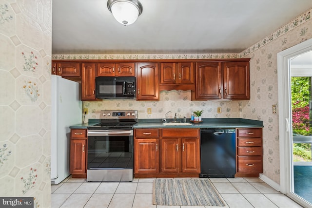 1176 Goldfinch Ln, Millersville, MD 21108 - kitchen featuring black appliances, a sink, dark countertops, light tile patterned floors, and wallpapered walls
