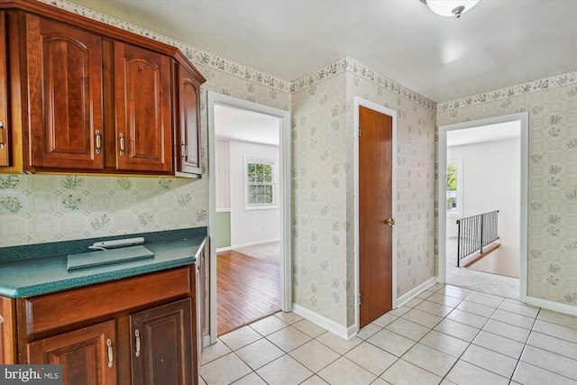 1176 Goldfinch Ln, Millersville, MD 21108 - kitchen with dark countertops, light tile patterned floors, and baseboards