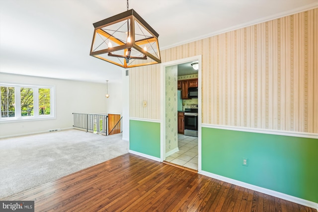 1176 Goldfinch Ln, Millersville, MD 21108 - spare room featuring a chandelier, hardwood / wood-style flooring, baseboards, wallpapered walls, and crown molding