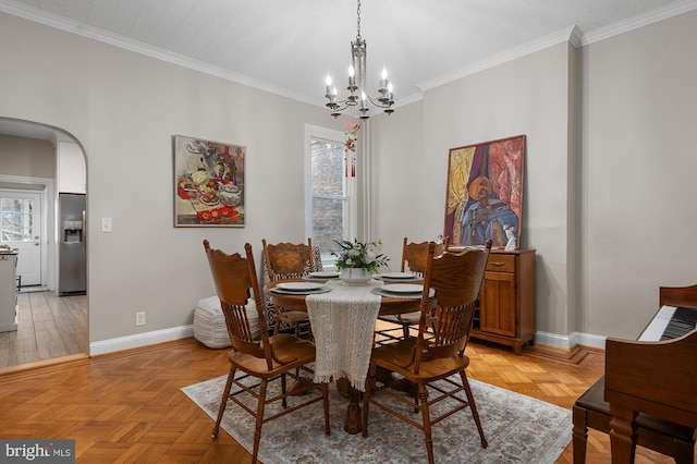 2332 E Baltimore St E, Baltimore, MD 21224 - dining area featuring arched walkways, a chandelier, baseboards, and crown molding