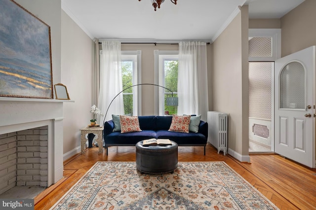 2332 E Baltimore St E, Baltimore, MD 21224 - living area featuring radiator heating unit, ornamental molding, and baseboards