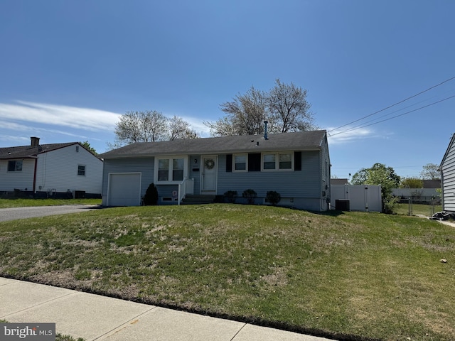ranch-style home with an attached garage, driveway, and central AC