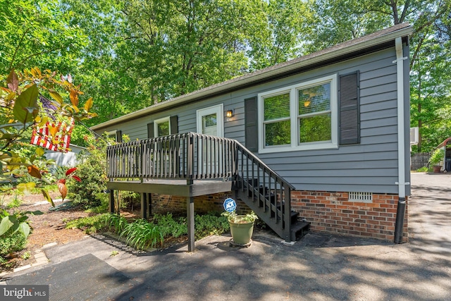 back of house with a wooden deck and crawl space
