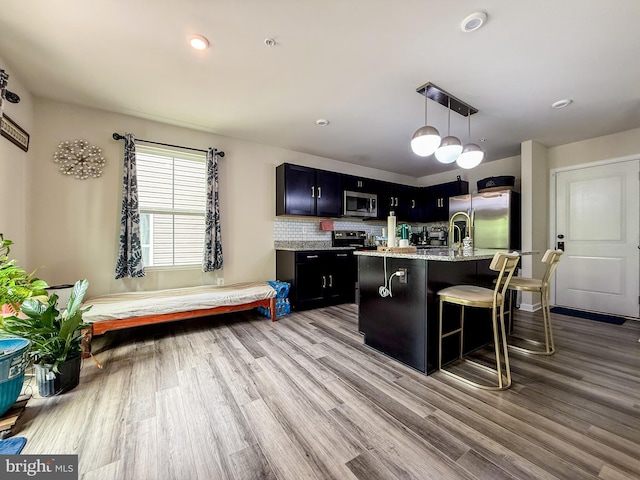 30 Sugarberry Dr, Elkton, MD 21921 - kitchen with stainless steel appliances, wood finished floors, dark cabinetry, a breakfast bar area, and recessed lighting