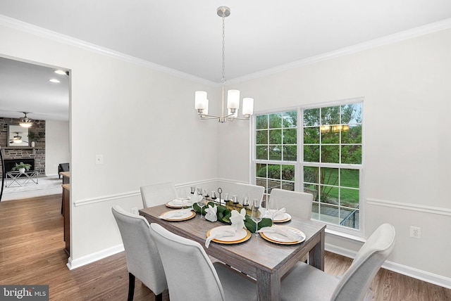 924 Towering Oak Ct, Purcellville, VA 20132 - dining space with a chandelier, dark wood-style floors, ornamental molding, baseboards, and a fireplace