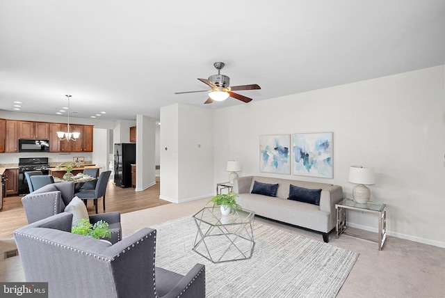 924 Towering Oak Ct, Purcellville, VA 20132 - living room with a chandelier, baseboards, ceiling fan, and light carpet