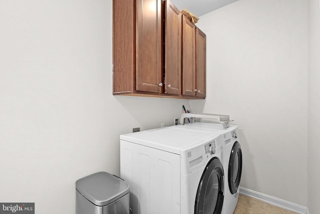 924 Towering Oak Ct, Purcellville, VA 20132 - clothes washing area featuring washing machine and dryer, cabinet space, and baseboards