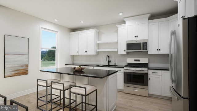 kitchen with stainless steel appliances, a sink, open shelves, dark countertops, and recessed lighting