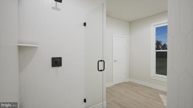 bathroom with wood finished floors and baseboards