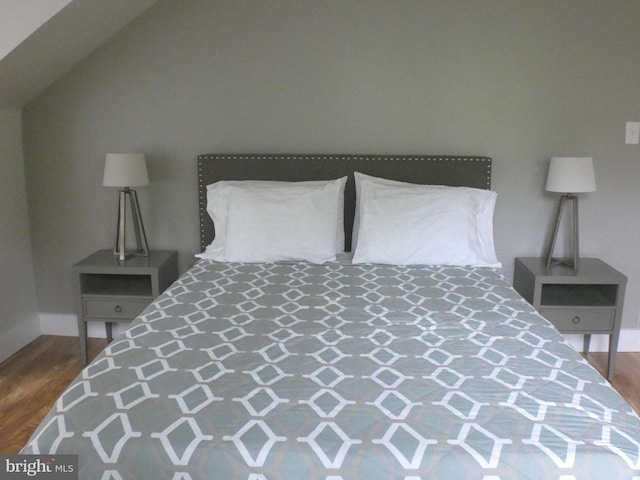 bedroom featuring wood finished floors and baseboards