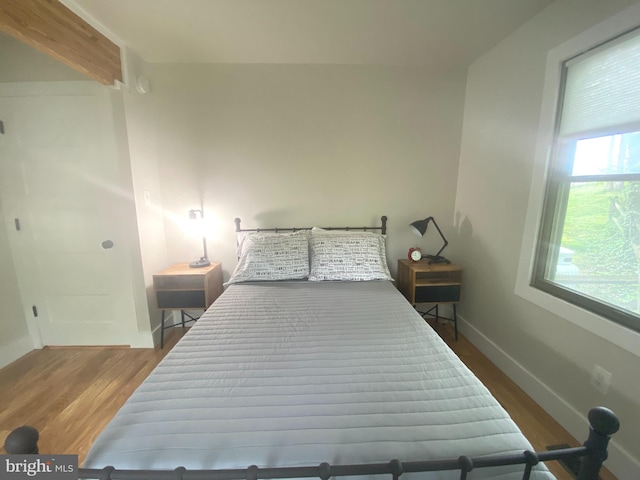 bedroom featuring wood finished floors and baseboards