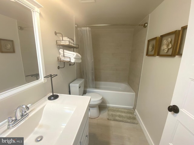 bathroom featuring toilet, vanity, and shower / bath combination with curtain