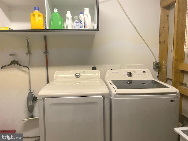 laundry area with independent washer and dryer