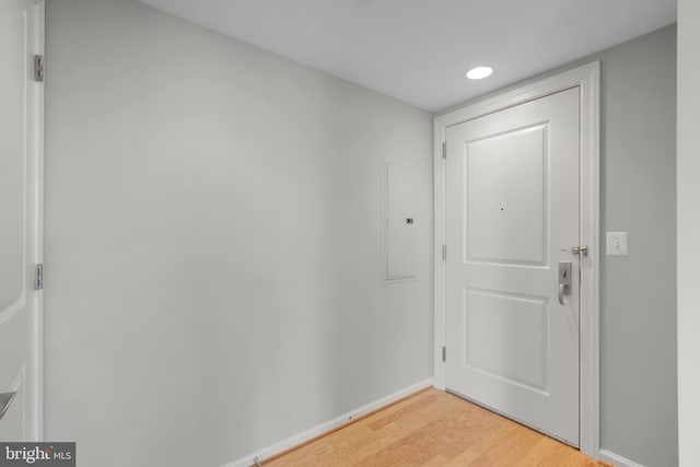 entryway with light wood-style floors, baseboards, and recessed lighting