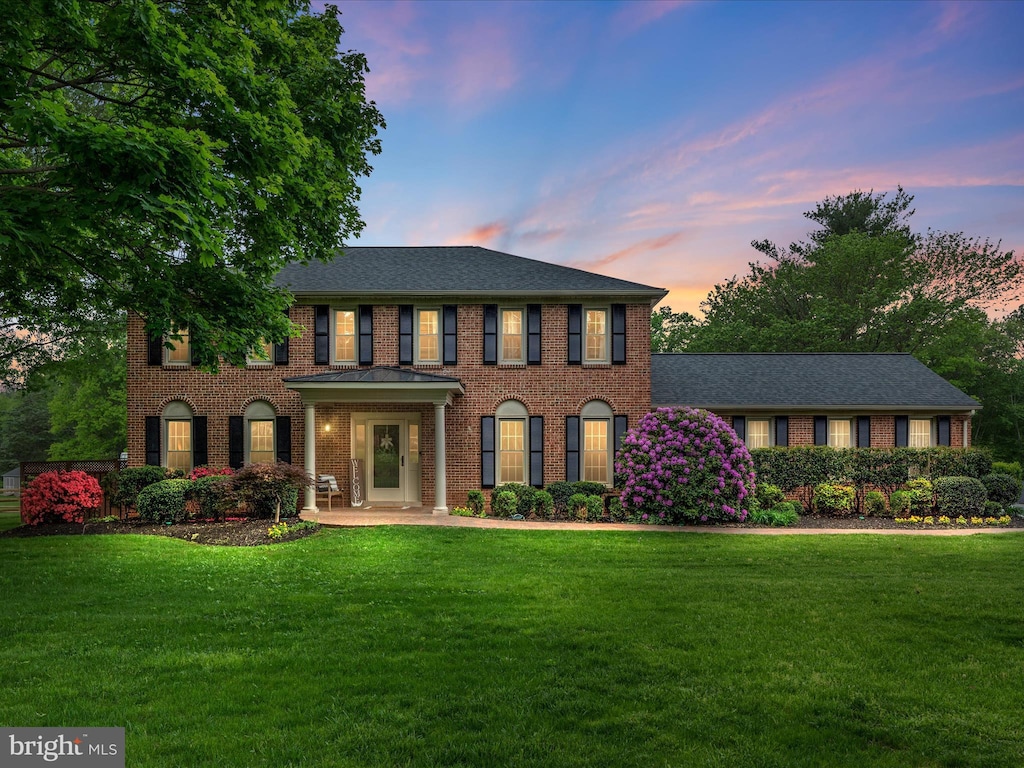 4002 Latham, Haymarket, VA 20169 - colonial-style house featuring a lawn, brick siding, and roof with shingles