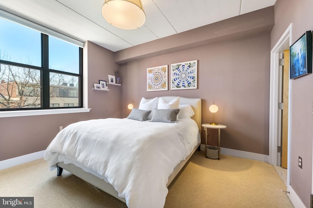 carpeted bedroom featuring baseboards
