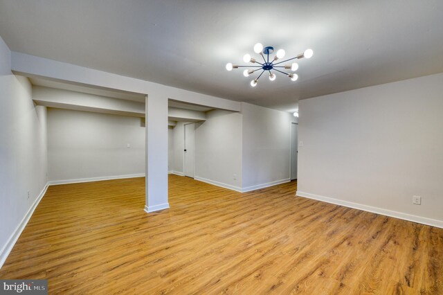 9815 Winands Rd, Randallstown, MD 21133 - finished below grade area with light wood-style floors, baseboards, and a chandelier