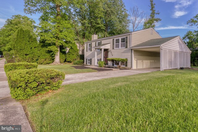 9815 Winands Rd, Randallstown, MD 21133 - raised ranch with concrete driveway, a front yard, a chimney, and an attached carport