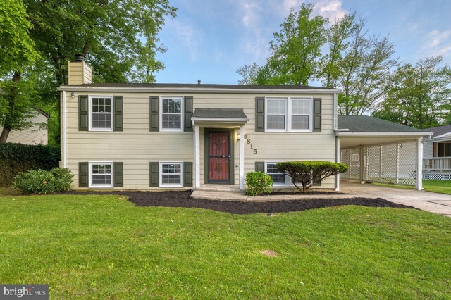 9815 Winands Rd, Randallstown, MD 21133 - raised ranch with concrete driveway, a chimney, a front lawn, and an attached carport