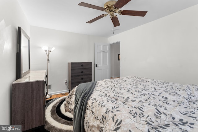 8031 Stratman Rd, Baltimore, MD 21222 - bedroom featuring wood finished floors, a ceiling fan, and baseboards
