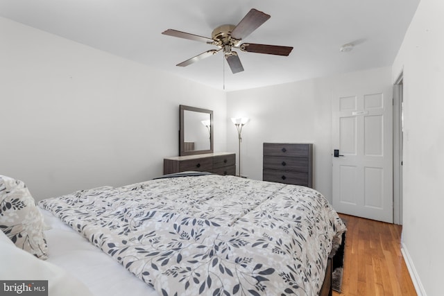 8031 Stratman Rd, Baltimore, MD 21222 - bedroom featuring wood finished floors, a ceiling fan, and baseboards