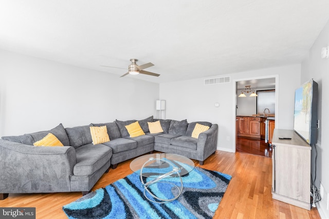 8031 Stratman Rd, Baltimore, MD 21222 - living room with light wood finished floors and ceiling fan