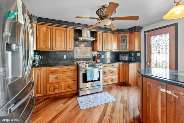 8031 Stratman Rd, Baltimore, MD 21222 - kitchen with stainless steel appliances, wall chimney exhaust hood, brown cabinets, and light wood finished floors