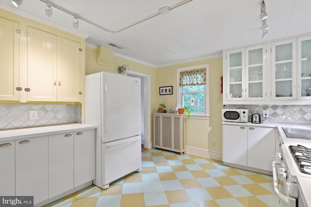 4901 40th Pl, Hyattsville, MD 20781 - kitchen featuring rail lighting, white appliances, light floors, crown molding, and light countertops