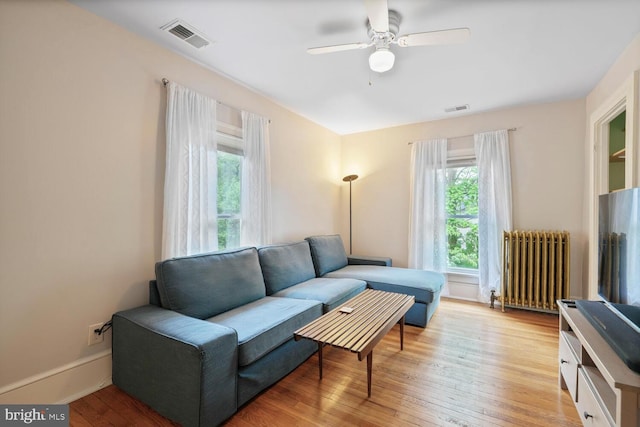 4901 40th Pl, Hyattsville, MD 20781 - living room with radiator, a ceiling fan, and light wood finished floors