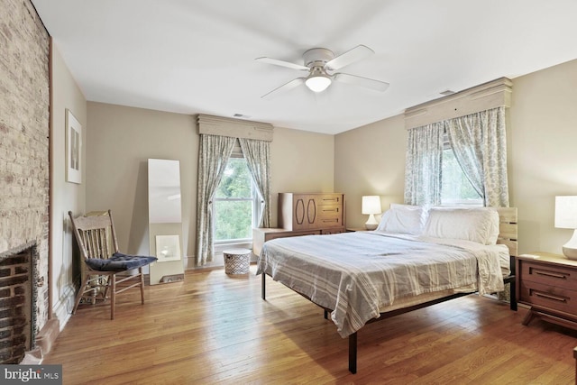 4901 40th Pl, Hyattsville, MD 20781 - bedroom with light wood finished floors, a fireplace, and ceiling fan