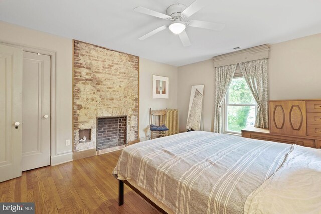 4901 40th Pl, Hyattsville, MD 20781 - bedroom featuring wood finished floors, a brick fireplace, and ceiling fan