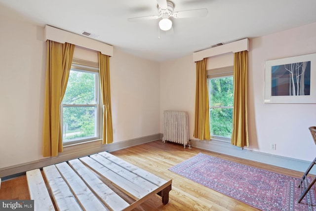4901 40th Pl, Hyattsville, MD 20781 - bedroom with radiator, wood finished floors, multiple windows, and baseboards